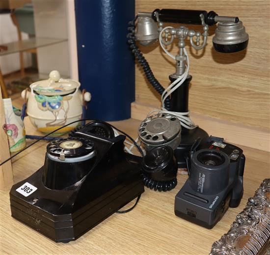 An American rotary wall phone, another and an Olympus camera